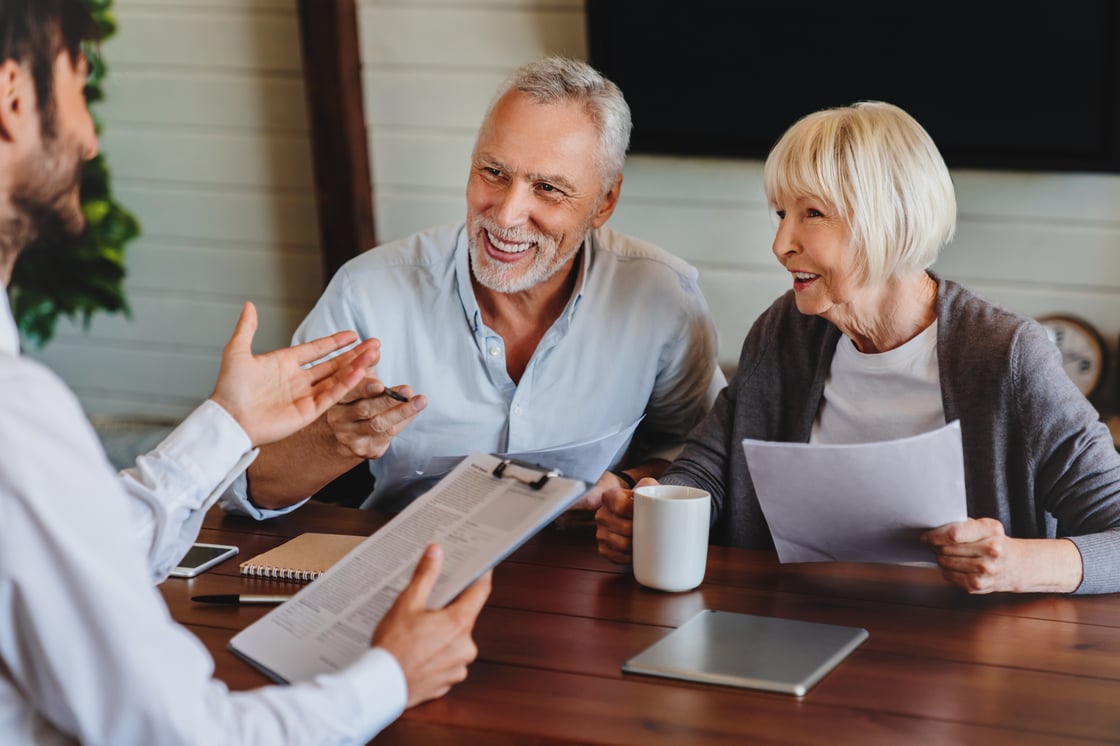 happy-aged-couple-consulting-with-insurance-agent-2022-06-21-17-44-33-utc